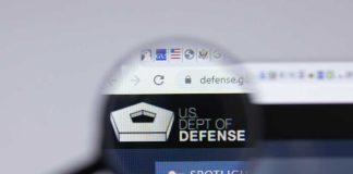Magnifying glass focusing on US Department of Defense website