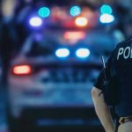 Baltimore Horror: Teens Swarm Elderly Man Police officer with patrol car and flashing lights.