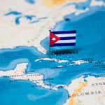 Fuel Blockade Exposed: Babies at Risk A small Cuban flag placed on a map highlighting Cuba in the Caribbean