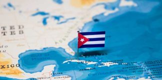 Fuel Blockade Exposed: Babies at Risk A small Cuban flag placed on a map highlighting Cuba in the Caribbean