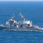 Gray naval warship cruising on open sea