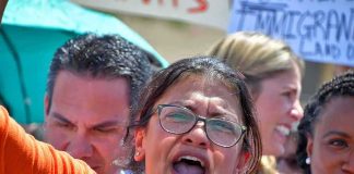 Woman with glasses shouting at a rally
