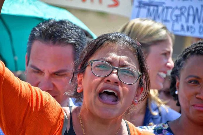 Woman with glasses shouting at a rally