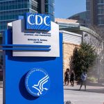 CDC campus entrance sign with modern buildings in background