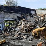 Burned building interior with collapsed charred debris