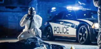 Drug Claim Crumbles — DA Calls It Salt forensic investigator photographing crime scene near police car