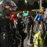 ICE Shooting Sparks Maine Firestorm Law enforcement officers facing protesters at night