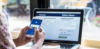 France Drops The Hammer On Teen Screens Hands using smartphone with laptop and coffee on cafe table
