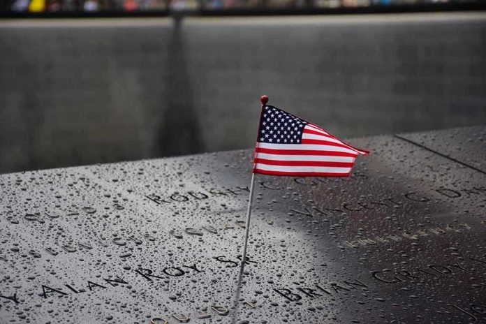 American flag on a rainy memorial nameplate.