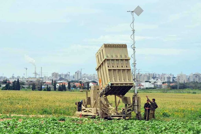 Military defense system deployed in a field with soldiers nearby