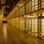 Son Delivers Brutal Message After His Mother’s Killer Is Executed Prison cell block corridor with barred cells and upper walkways