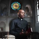 Texas Priest Laicized After Calling Two Popes ‘Usurpers’ Priest talking with a visitor inside a church