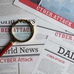 Newspapers with Cyber Attack headlines and a magnifying glass.