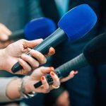 Homicide Ruling Flips Case Overnight Reporters holding colorful microphones