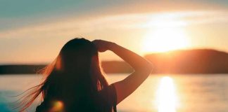 The Cost of Redefining What a Woman Is Silhouette of a person looking at a sunset over water
