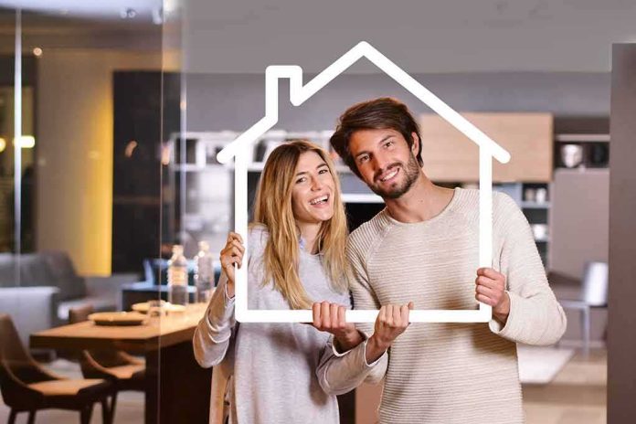 Couple holding a house-shaped frame indoors
