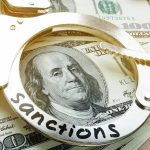 Handcuffs on U.S. hundred-dollar bills
