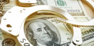 Handcuffs on U.S. hundred-dollar bills