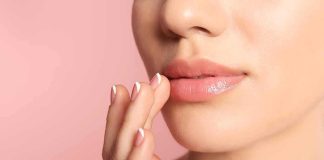 Close-up of woman's lips with hand touching