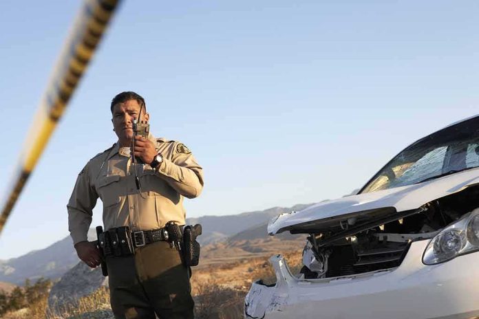 Police officer at crash scene near damaged white car