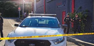 Police Seize 2,400 Stolen Catalytic Converters Worth $4.3M Police car behind yellow caution tape on a city street