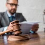 Close-up of a wooden judge’s gavel on a desk