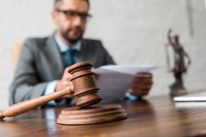 shutterstock_1238343010 Close-up of a wooden judge’s gavel on a desk