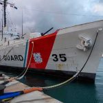 Coast Guard cutter moored at a pier
