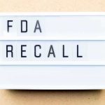 Lightbox sign reading FDA recall on beige background