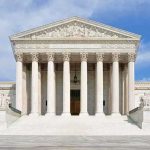 Supreme Court Nukes Drug-User Gun Ban Front view of the Supreme Court building with large columns and steps under a blue sky