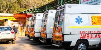 Row of ambulances parked outside a hospital entrance