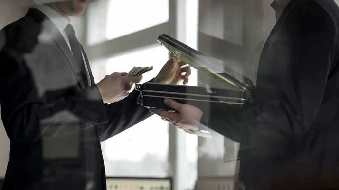Two men in suits exchanging cash and a briefcase
