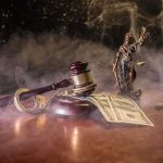 Judge's gavel with handcuffs and cash on a smoky table