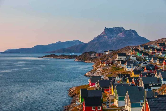 Colorful coastal town with mountains and sea at sunset