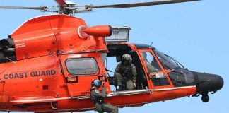 Rescue helicopter with crew performing hoist operation