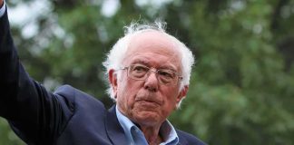 older man in suit and glasses outdoors