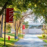 Charlie Kirk Honored Where He Was Killed One Year Ago Tree-lined campus walkway with red banners