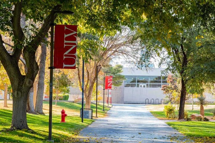 shutterstock_1587184345 Tree-lined campus walkway with red banners
