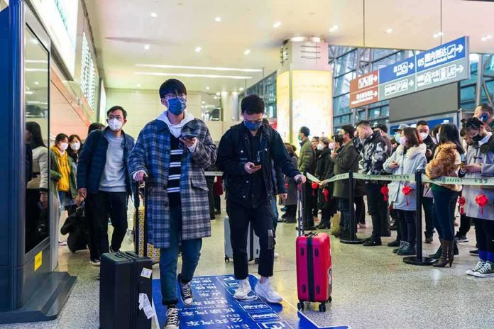 Akira Fukuzawa among masked travelers at a busy train station