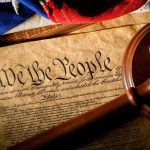 FTC Hits Trans Health Powerhouse U.S. Constitution with gavel and flag