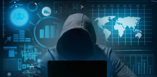 AI Chatbot Down Together — Coincidence Or Cover? Hooded figure using a laptop in a dark room with data graphics