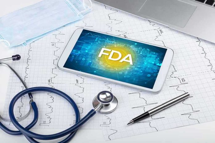 shutterstock_1701445117 Tablet with FDA on screen amid medical tools and ECG charts