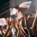 American flag waved by crowd