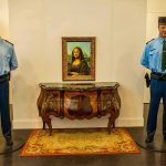 Picasso Protesters GUILTY — See Their Sentence Two uniformed guards flanking a framed portrait on a wall