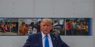 Donald Trump speaks at a podium with arms outstretched