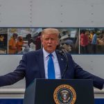 Quantum Gambit Puts U.S. Encryption On Notice Donald Trump speaks at a podium with arms outstretched