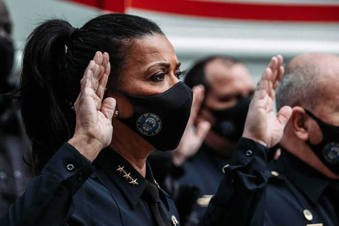 shutterstock_1897872601 Police officers wearing masks raise right hands during oath ceremony
