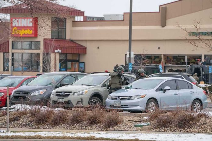 shutterstock_1941391645 police officers in tactical gear beside cars in a snowy parking lot