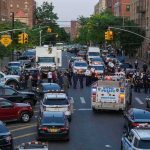 14-Year-Old SHOT Steps From NYC Playground Police vehicles and officers block a city street during an active scene