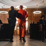 Ghislaine Maxwell Convicted But The Real Scandal Lurks Elsewhere Prisoner in orange jumpsuit escorted by officer in a courtroom